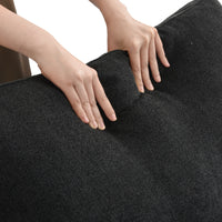 Extra Cover Set in Black — close-up of the boucle weave as hands press into the cushion
