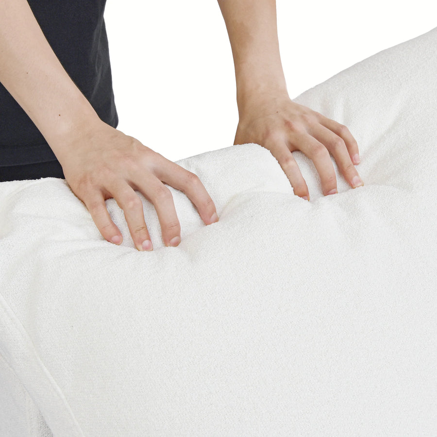 Extra Cover Set in White — close-up of the boucle weave as hands press into the cushion